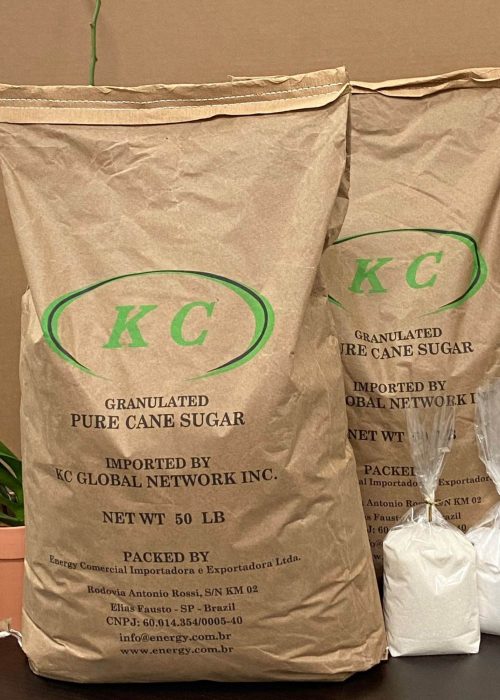 Two bulk 50 lbs bags of KC Global's granulated cane sugar and organic cane sugar, both adorned with our logo, showcasing our premium sugar supply products